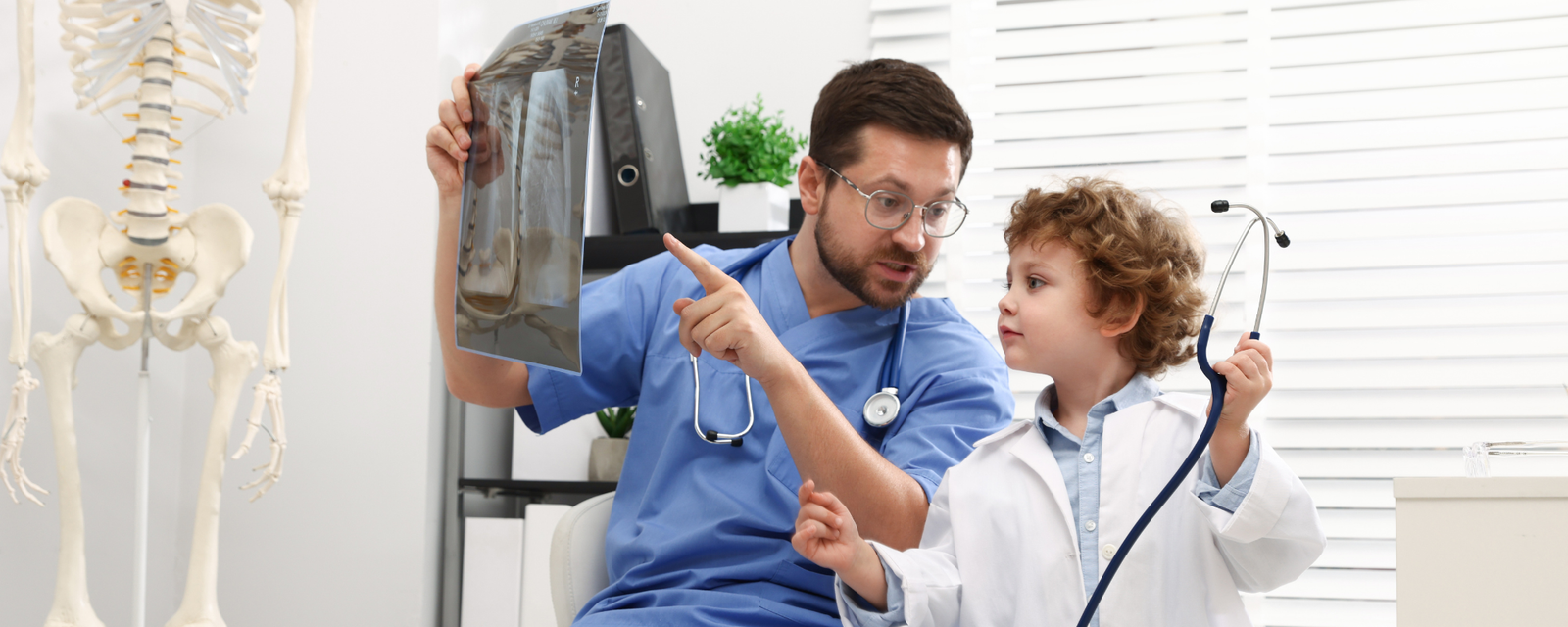 Pediatrician with a young child during a well-baby visit
